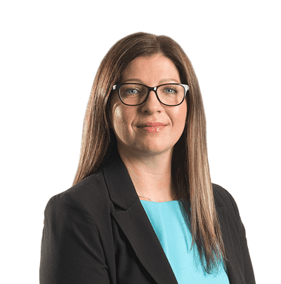 Linda Jardine head shot, a smiling female with brown straight hair, wearing glasses, a blue blouse and a black blazar jacket